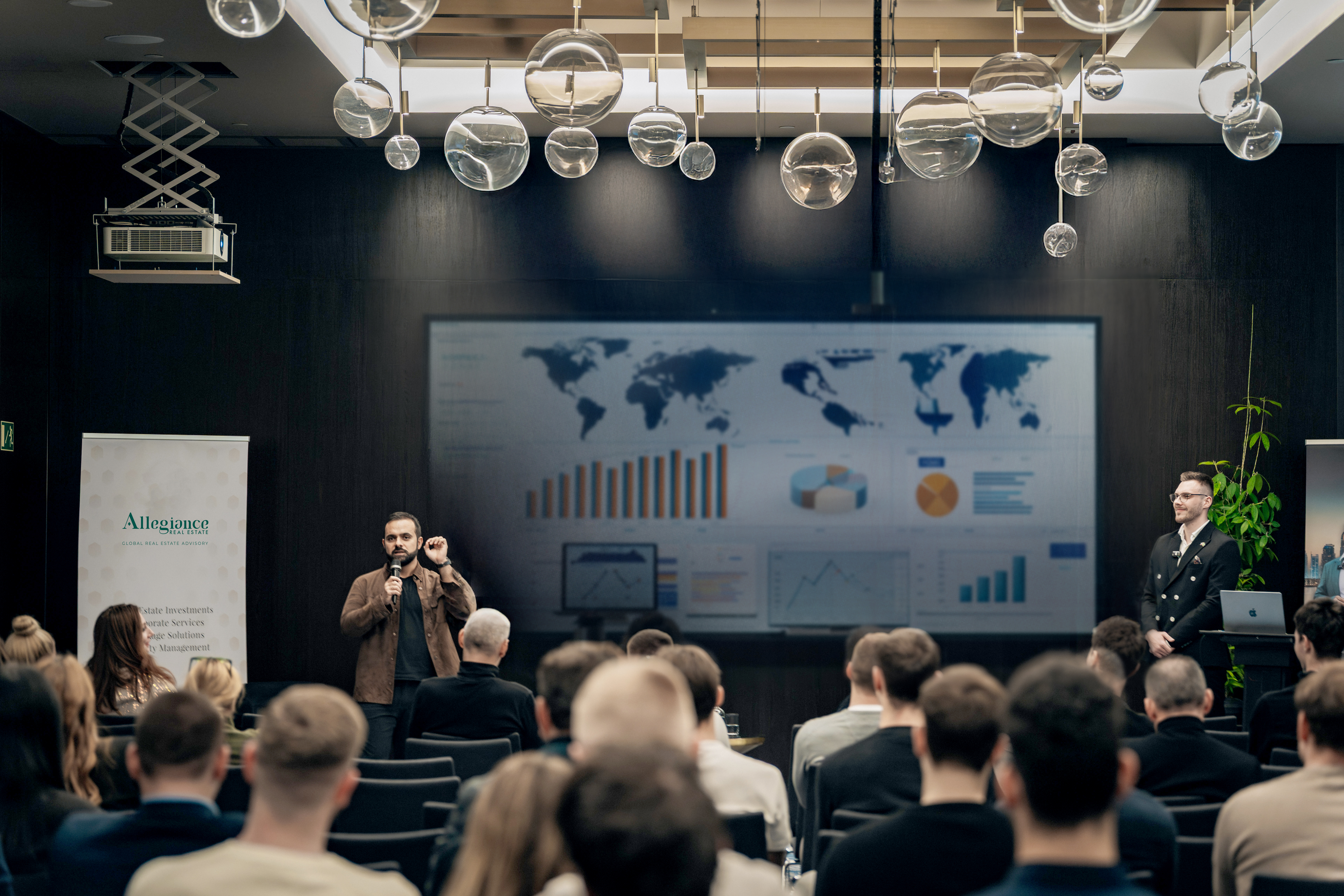 Allegiance presenting Dubai market data to a seated audience of investors at an international roadshow